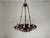 An exceptional 1940s hand-forged iron chandelier featuring intricate Gothic and medieval-inspired craftsmanship. The...