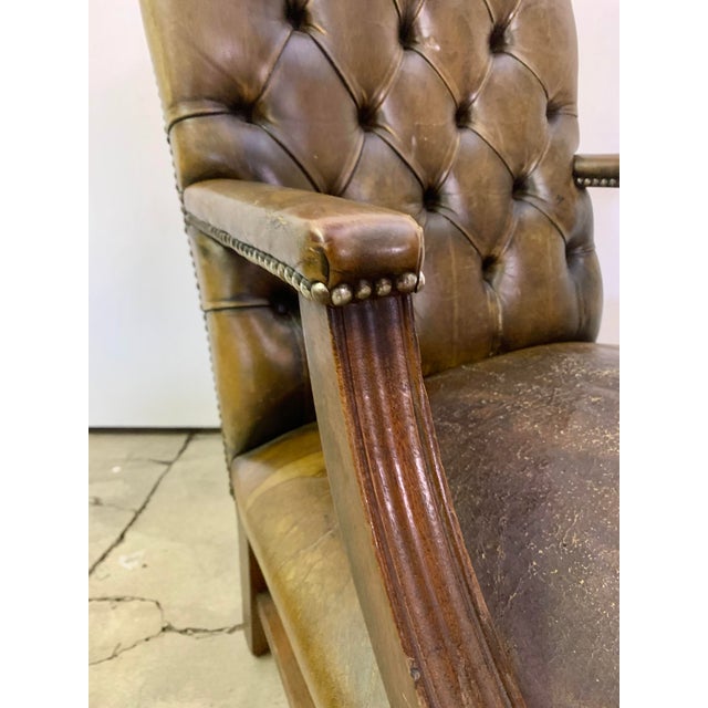 This Mahogany and Leather Desk Chair is of a Georgian Revival Style. Having Square Fluted Legs and an "H" Frame for Extra...