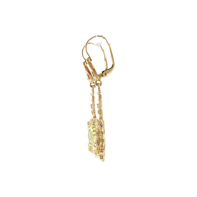A pair of mid-century Victorian revival drop earrings featuring lab-grown green sapphire stones. Crafted from 14k yellow...