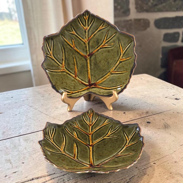 These Glazed Stoneware Roscher Leaf Shaped Olive Green Serving Plates are a unique and contemporary addition to any dining...