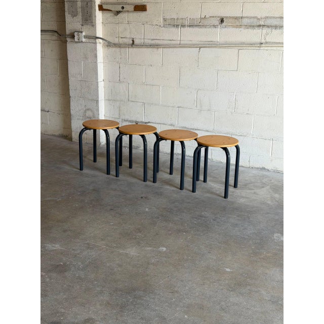 Beautiful set of four vintage Danish stools featuring minimalist Scandinavian modern design with round wooden seats and...
