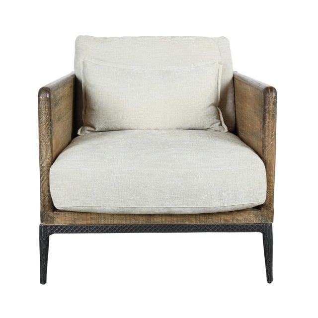 Unique modern club chair with handsome salvaged pine wood frame. Hand hammered iron legs and ivory toned plush cushions....