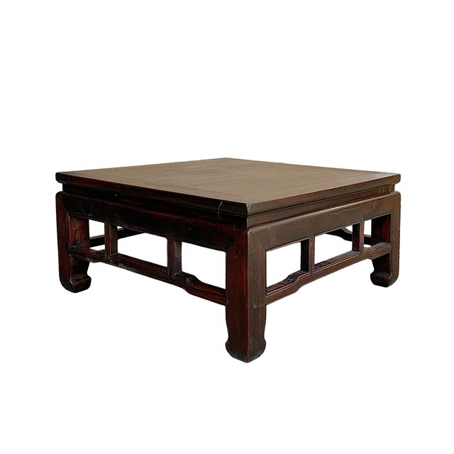 This elegant Ming-style Kang table is crafted from natural wood with a rich, reddish-brown finish that highlights the...