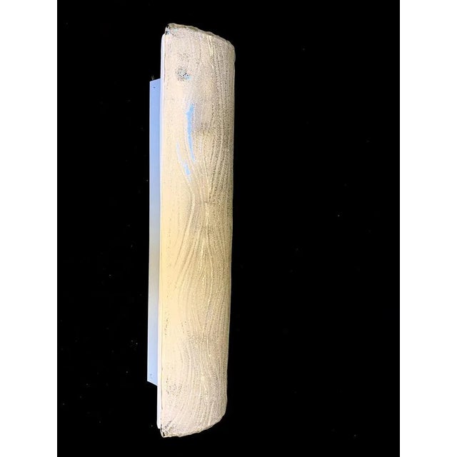 Single wall light in murano attributed mazzega company. around 1980. transparent paste in handmade glass, worked on a...