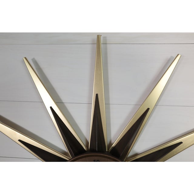 Stunning vintage black & gold starburst wall clock by Elgin. This clock is in good working condition. A new mechanism has...