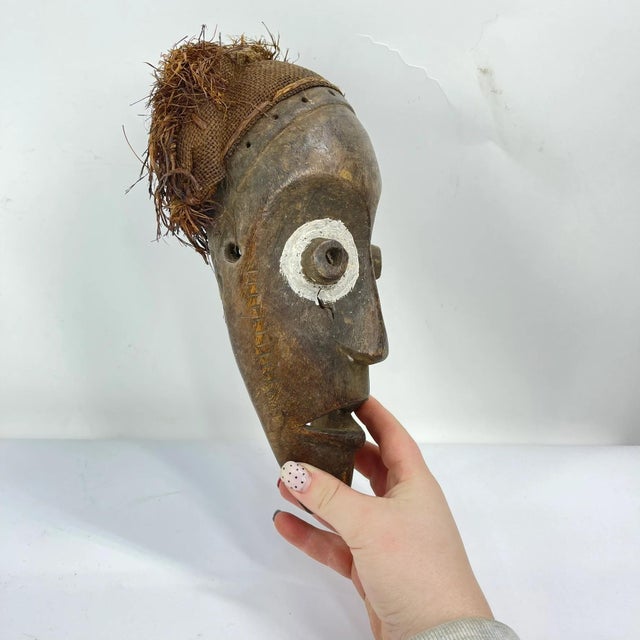This mask reflects the deep spiritual and social role of ritual art in African cultures, combining characteristics...