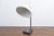 - Vintage white desk light - White metal shade and blackened metal base - Shade diameter: 17 cm. This piece has an...