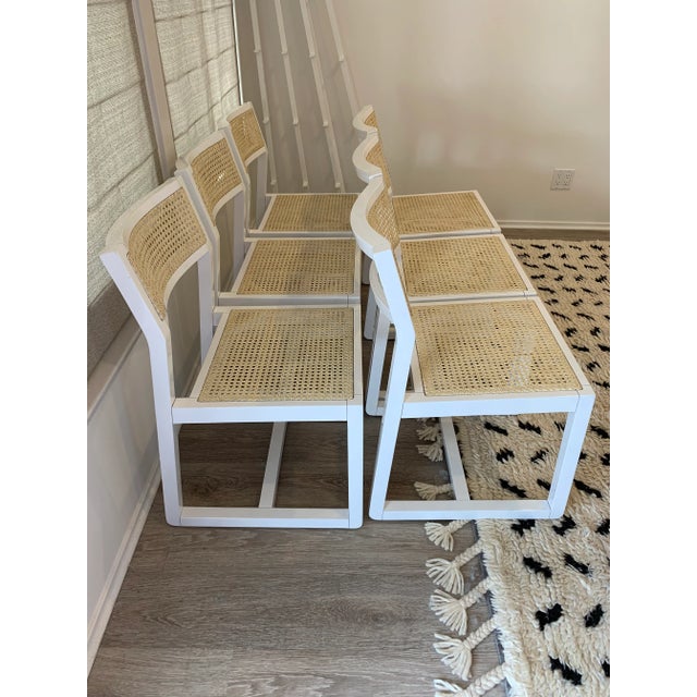 Dining chair proudly sits at the crossroad of then and now, combining traditional caning and modern hi-gloss white...