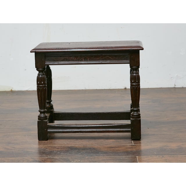 An English oak joint stool dating to the 19th century, crafted in the traditional style of earlier 17th-century examples....
