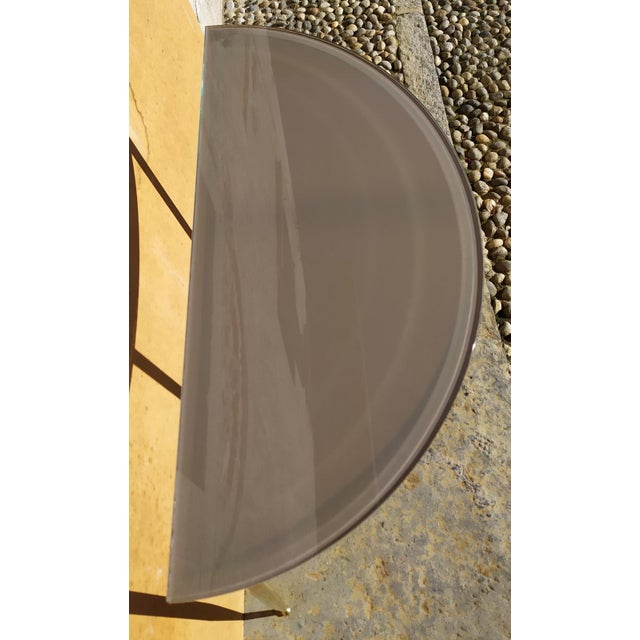 The creator if this console is unknown. Under the glass top, there is a wooden support surface covered with paper, to...