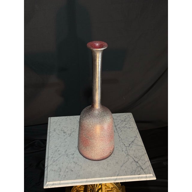 A striking vintage studio pottery vase featuring a richly textured speckled glaze in deep charcoal, burgundy, and muted...