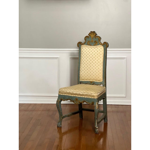 18th century hand carved Italian Rococo paint decorated and parcel gilt upholstered side chair. A dramatic statement chair...