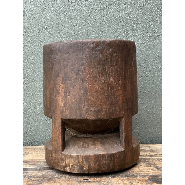 This exceptional antique hand-carved wooden mortar represents the pinnacle of primitive functional art. Carved from a...