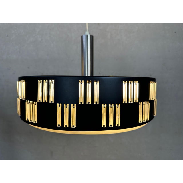 Unique space age pendant lamp with diffuser. Surrounded by cylindrical glass tubes. 3 Bakelite E27 sockets. Light and...