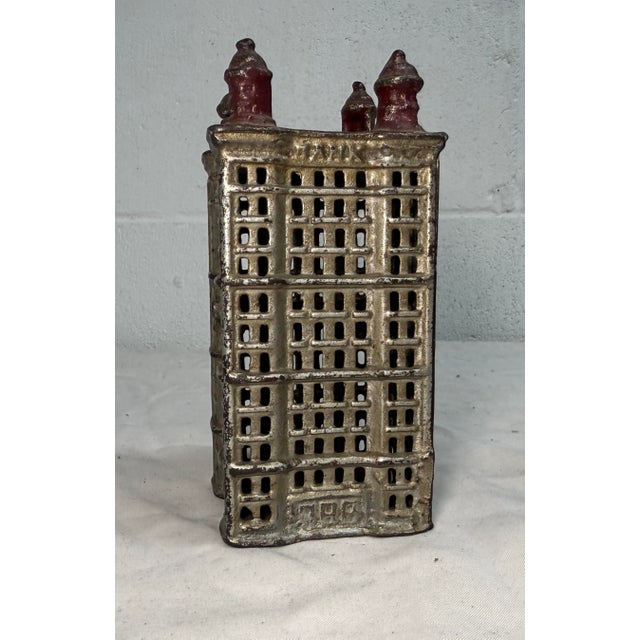 This Antique A.C. Williams Cast Iron Skyscraper Still Bank is a unique and collectible piece made in Ohio during the early...