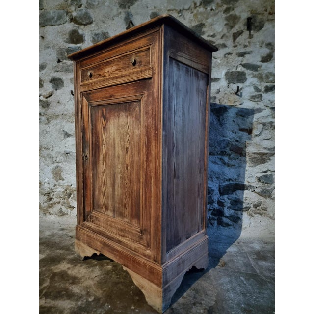 This rustic french pine cabinet was crafted in france during the 19th century and reflects the timeless character of...