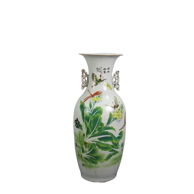 This vintage Chinese Famille Rose porcelain vase is adorned by hand painted plants, flower, and dragon flies on one side...