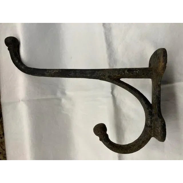 The real thing. Thick and heavy cast iron wall hooks Unusually large. With well-deserved patina. Four screw-holes will...