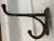 The real thing. Thick and heavy cast iron wall hooks Unusually large. With well-deserved patina. Four screw-holes will...