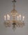 A chandelier with six finely-cut crystal, S-curve arms, molded and cut crystal candle cups, bobeches, mounts, and body....