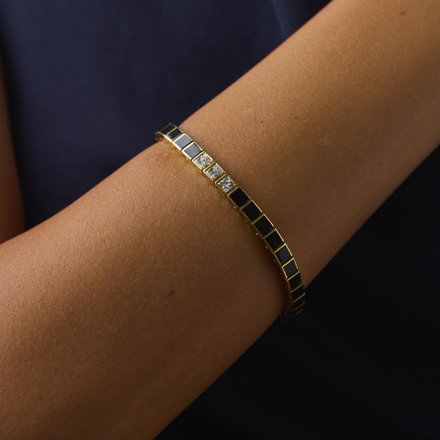 This elegant vintage diamond and onyx tennis bracelet is a bold design from the 2000’s, featuring 3 princess cut diamonds...