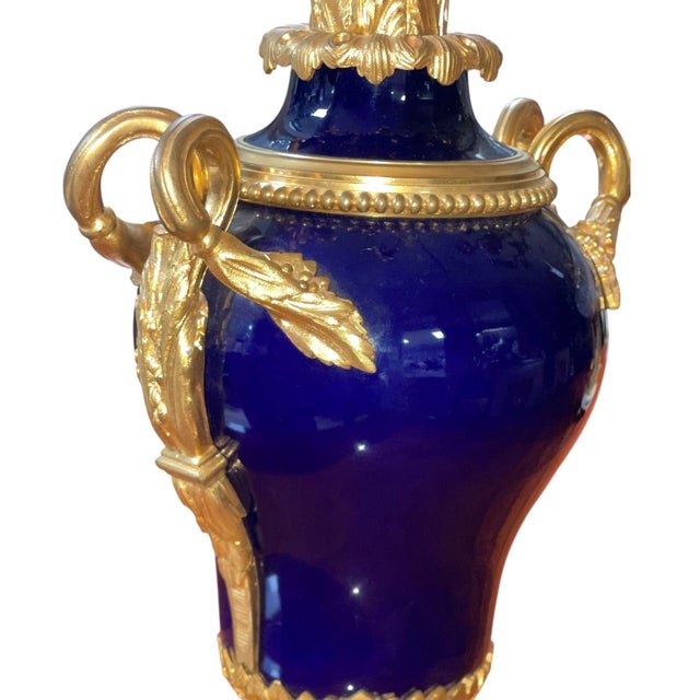 An exceptional pair of 19th century French gilt bronze and deep cobalt blue porcelain candelabras, masterfully executed in...