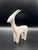 A refined minimalist antelope sculpture defined by its elongated horns, graceful neck, and fluid silhouette. This piece...