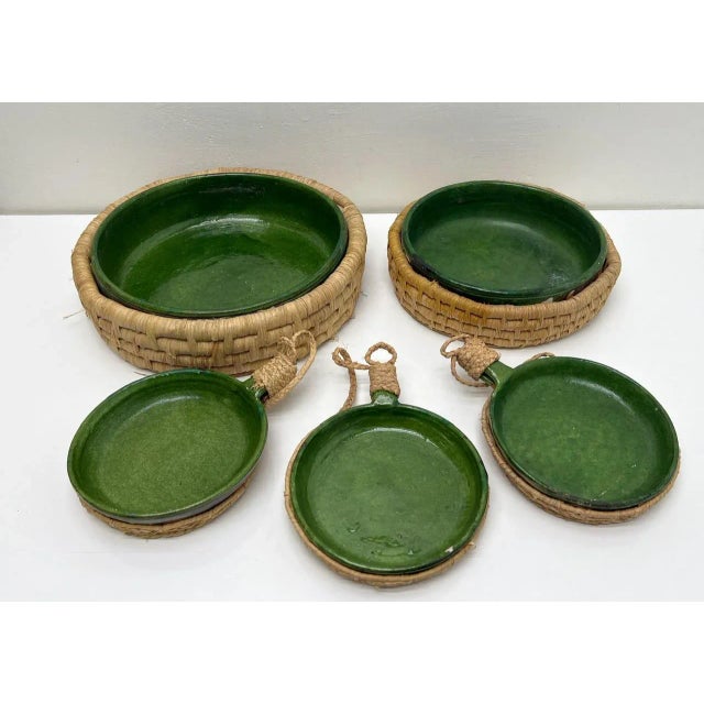 A charming set of handmade green ceramic bowls with natural woven straw bases, the perfect blend of rustic and...