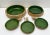 A charming set of handmade green ceramic bowls with natural woven straw bases, the perfect blend of rustic and...