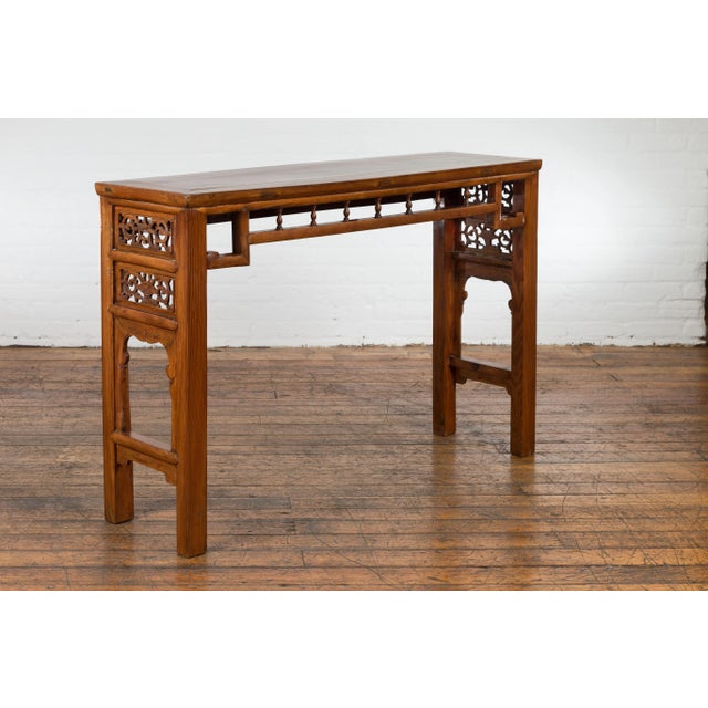 A Chinese late Qing Dynasty period altar brown lacquered console table from the early 20th century with scrolling foliage-...