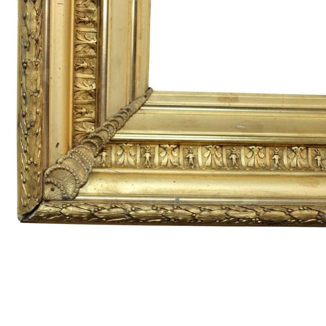 This oversized antique art frame is crafted from wood with a gilt finish, dating to approximately 1890. The frame features...