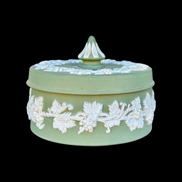 This vintage Wedgwood round lidded box is made of traditional green Jasperware, an unglazed stoneware known for its smooth...