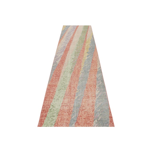 Hand-knotted in wool, this 3x12 abstract runner rug featuring polychromatic geometric patterns is a new addition to the...