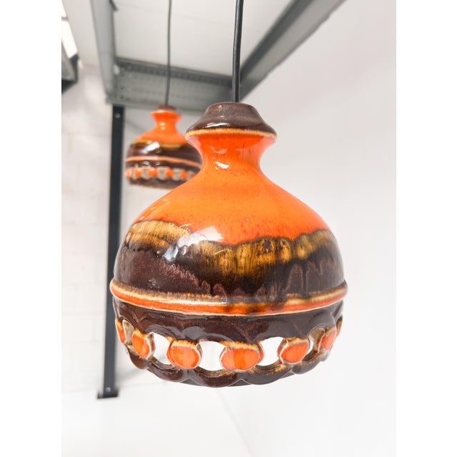Charming vintage ceiling lamp set by pan leuchten. The ceramic lamps are finished in warm orange and brown tones. The...