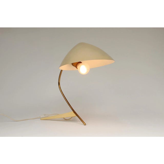 Large table lamp, made in Germany in the mid-1950s. Thin aluminum lampshade, beige. Brass arm with ball joint. Yellow...