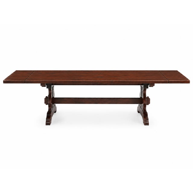 Impressive antique-style trestle dining table featuring a substantial plank-style top finished in a rich, warm walnut tone...
