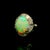 A striking and contemporary platinum cocktail ring featuring a captivating opal. The opal weighs 3.67 carats and displays...