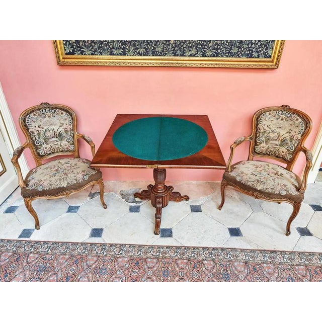 Elegant pair of armchairs in the Rococo style with hand-woven tapestry upholstery with floral motifs and a scene with...