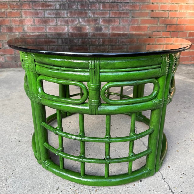 Step into a stylish and timeless aesthetic with this stunning vintage green rattan and bamboo coffee table, perfect for...