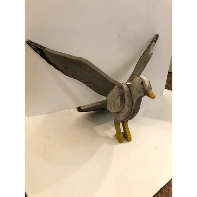 A wonderful folk art carved and hand painted wooden seagull on base having an authentic weathered patina and faded grey,...