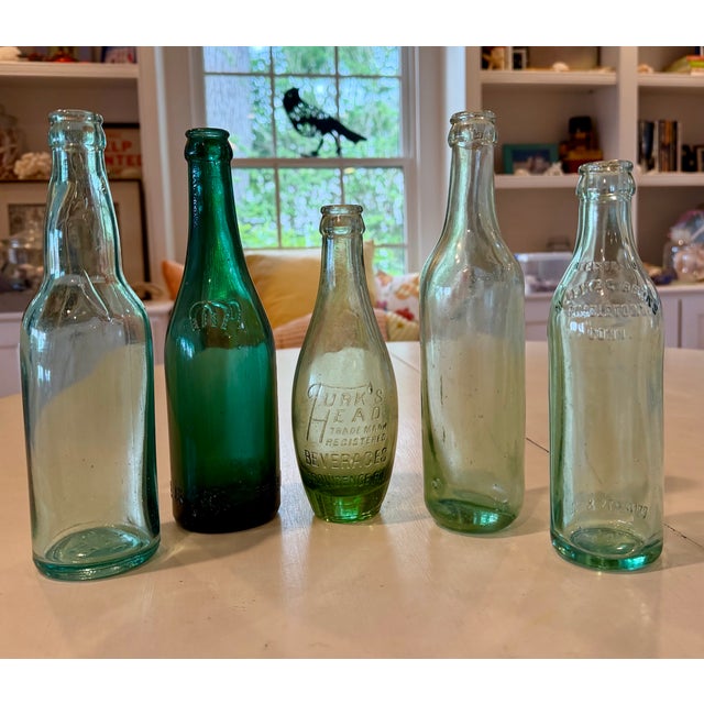 Vintage group of five soda and other collectible beverage bottles in various shades of green lighten up and bring...