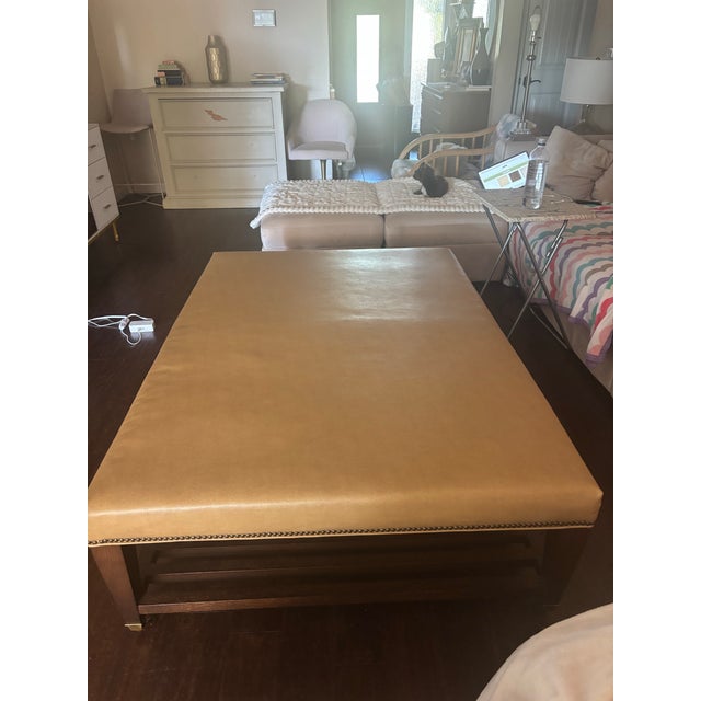 Lee Industries Large Leather Cocktail Ottoman in Apex Sand - nailhead trim along the base and a lower storage shelf. Tan...