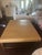 Lee Industries Large Leather Cocktail Ottoman in Apex Sand - nailhead trim along the base and a lower storage shelf. Tan...