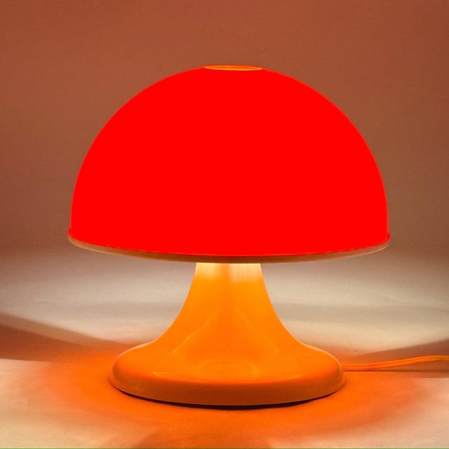 Italian Space Age mushroom table lamp produced during the 1970s. The lamp features a rounded orange diffuser resting on a...