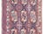 An early 20th-century Persian Yamout rug, handwoven in a distinctive tribal vocabulary, with a series of stylized floral...