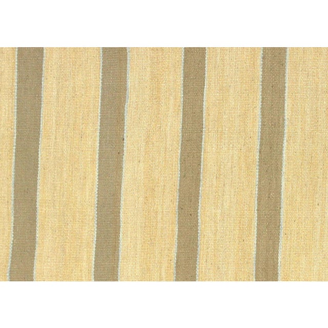 This vintage Egyptian Kilim, measuring 6'6" x 9'7", is handwoven with wool on a cotton foundation in the Fustat region of...