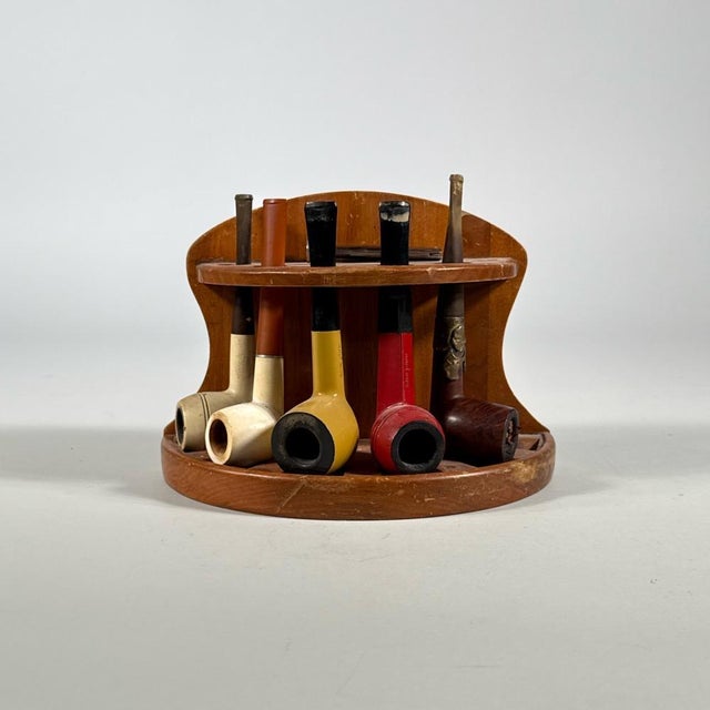 A seven-piece smoking set, including (i) a vintage wooden pipe stand or rack, circular in form with a shaped, scalloped-...