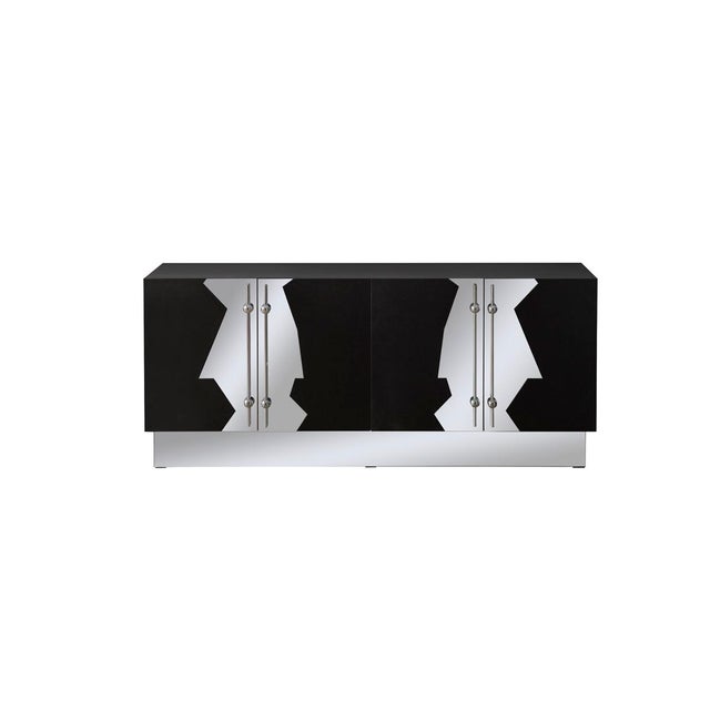 The Callista Sideboard features an Art deco-inspired design on the doors with a solid wood body and stainless-steel...