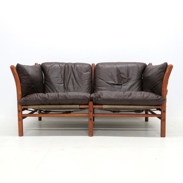 Stunning leather settee designed by Arne Norell in the early 1960s and produced by Aneby Møbler, Sweden, with thick, dark...