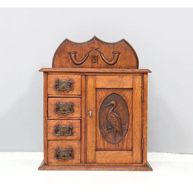 Stunning and rare Arts & Crafts wall cabinet. Striking Dutch design from the 1900s. Solid oak base with four original...